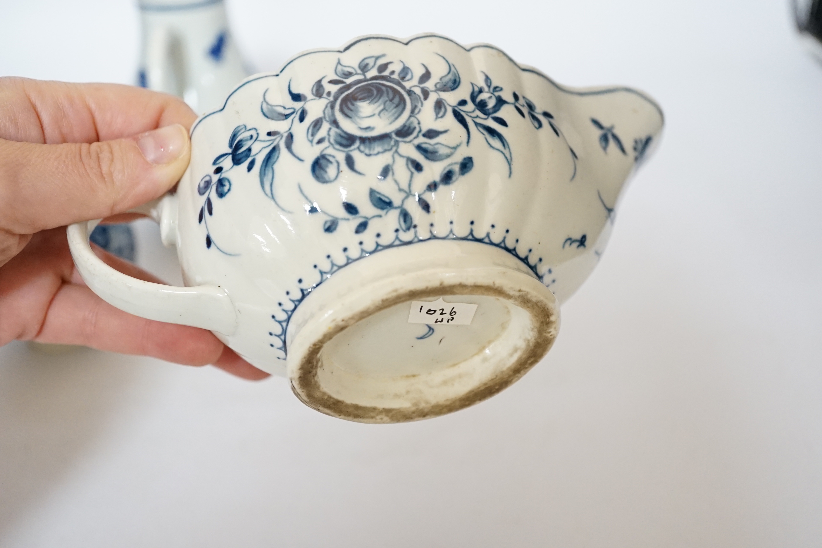 A Worcester rose pattern sauceboat c.1770 and two three flowers pattern milk jugs, largest 18cm wide